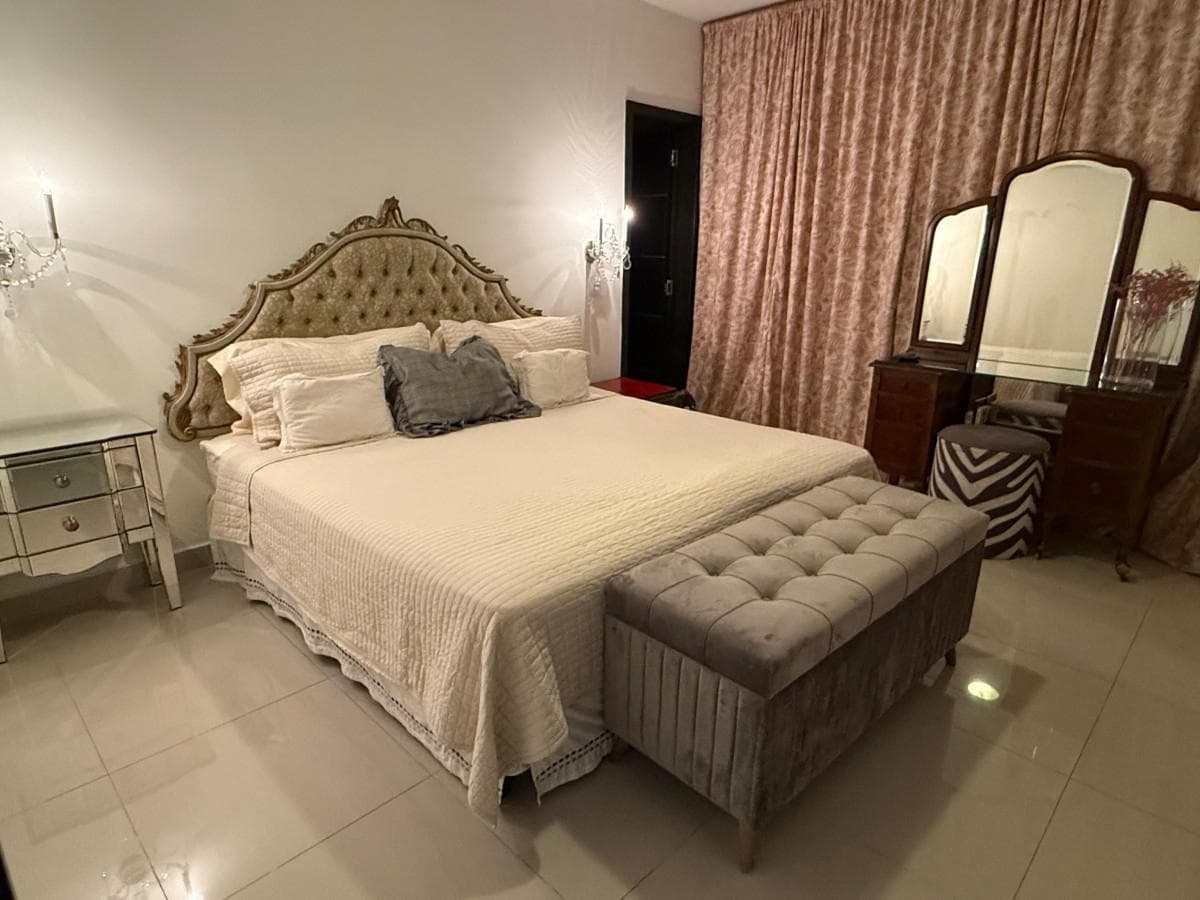 Bedroom with an upholstered headboard and vanity in an apartment at PH Joy Tower, San Francisco, Panama City
