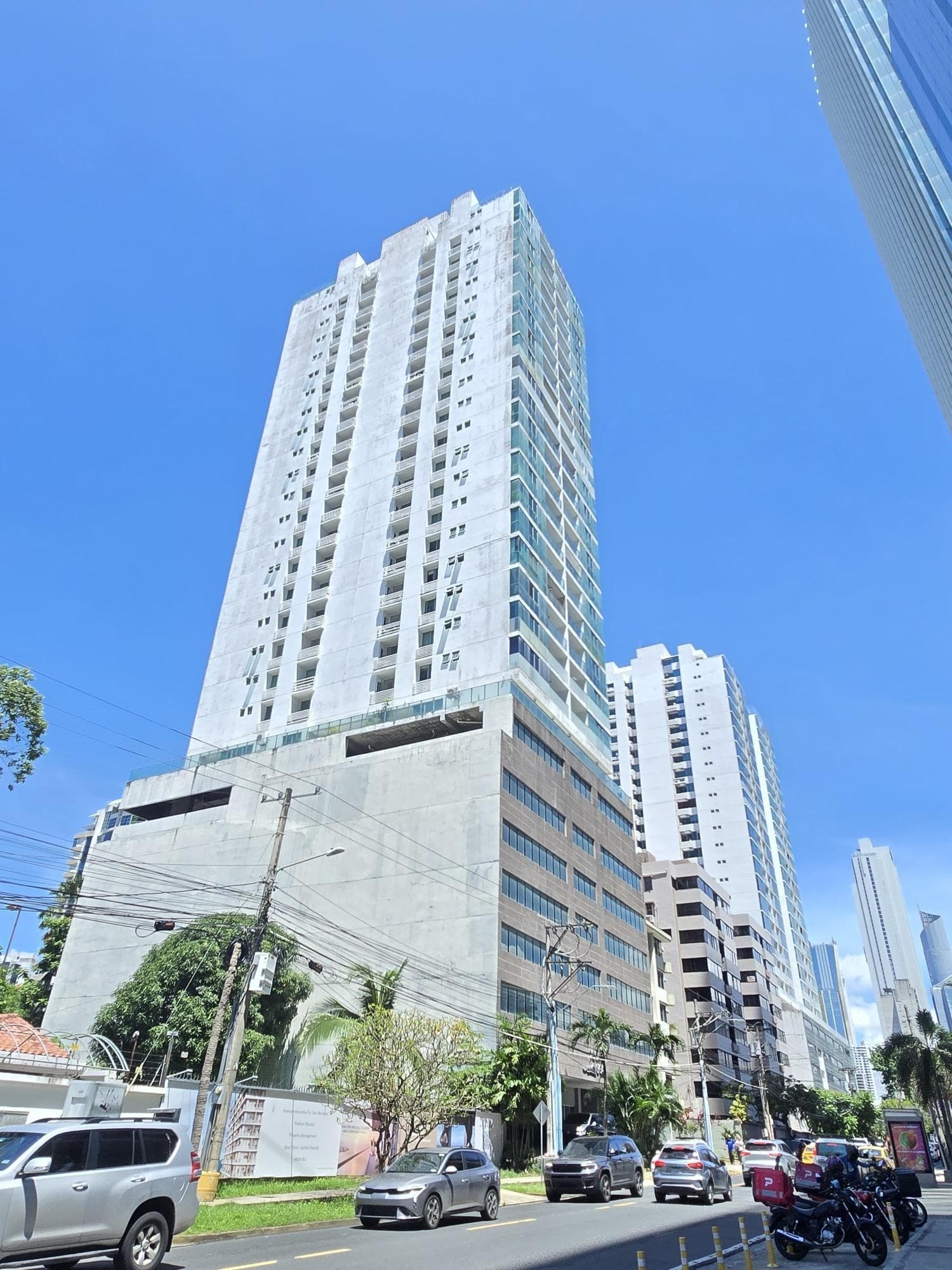 Street view of the Pacific Sea residential tower rising above its podium, Punta Paitilla, Panama City