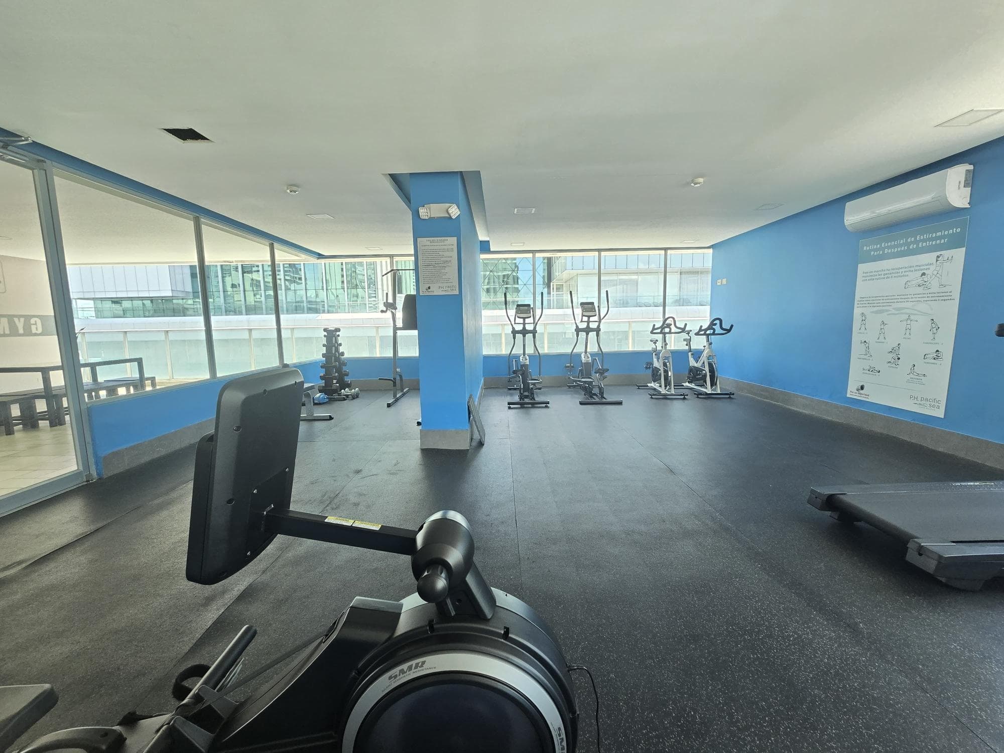 Gym with cardio machines and glass walls in the Pacific Sea tower, Punta Paitilla, Panama City