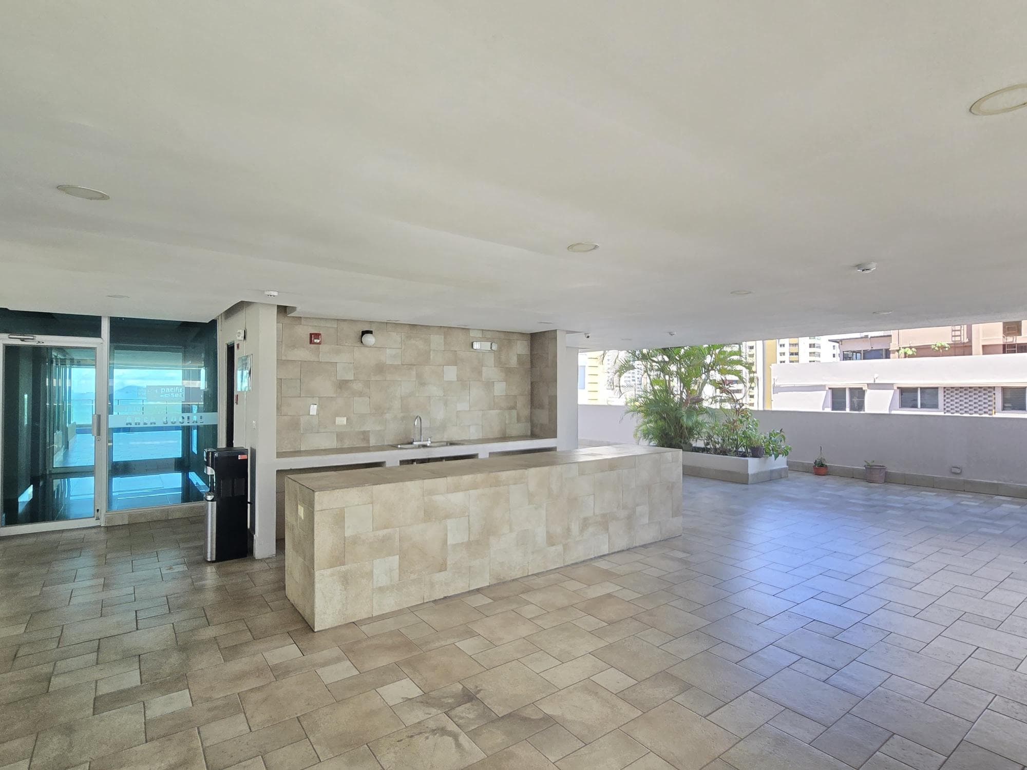 Social area with a stone bar and open terrace in the Pacific Sea tower, Punta Paitilla, Panama City