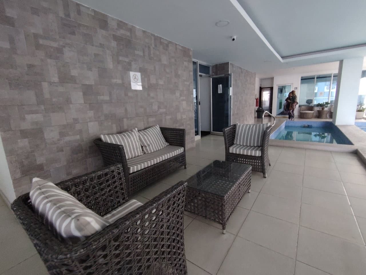 Covered lounge with wicker seating beside the jacuzzi at PH WaterView, San Francisco, Panama City