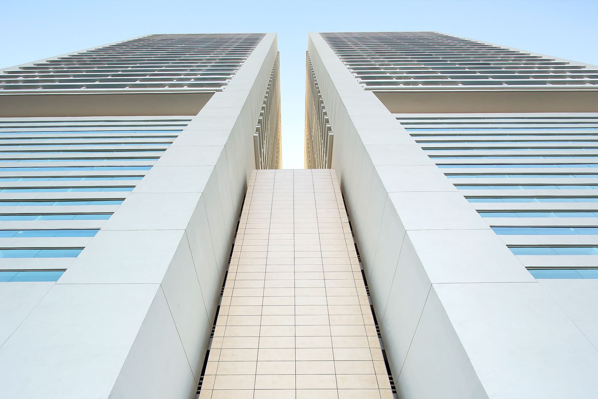 Upward view between the two towers of The Towers Residences