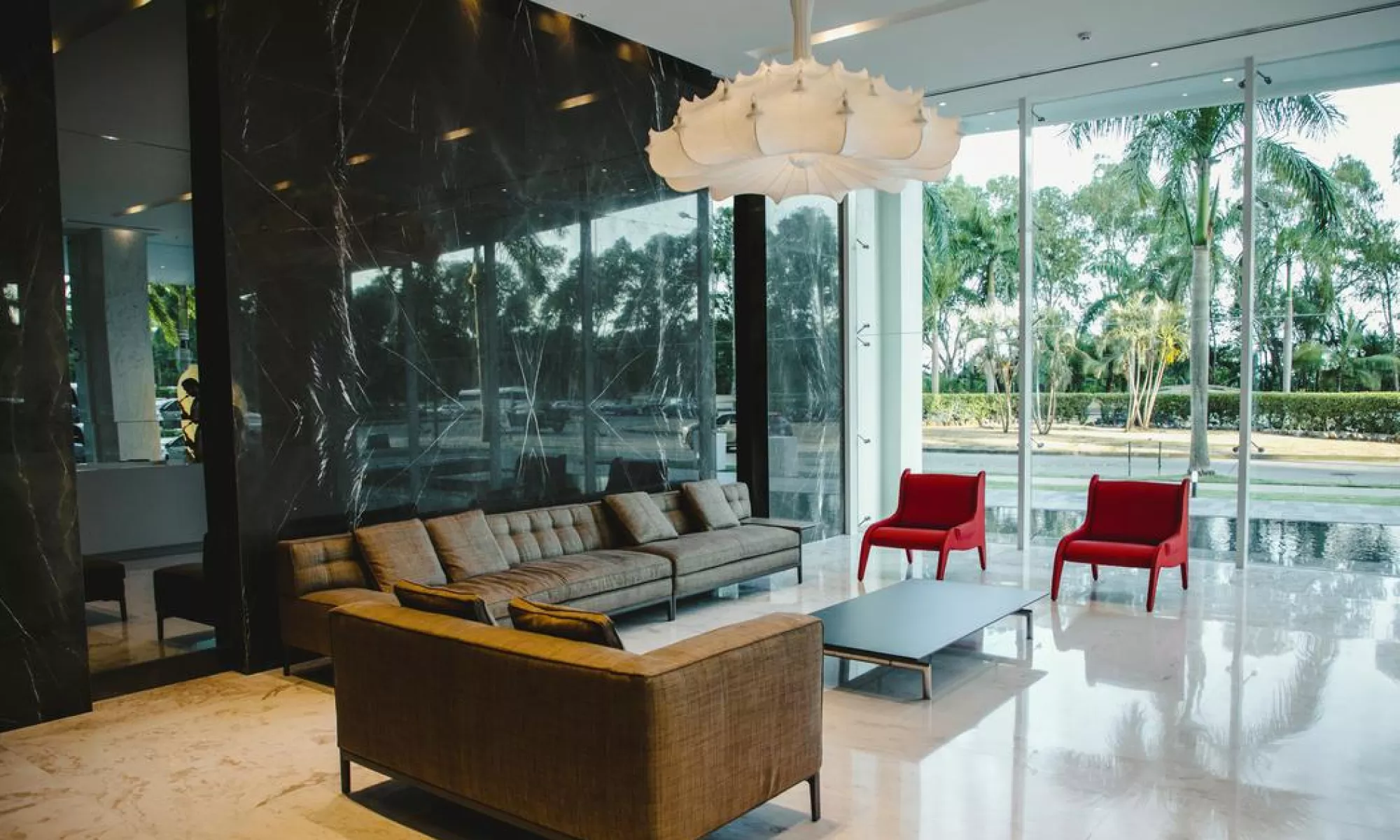 Glass-walled lobby lounge with marble feature wall at Marea II in Costa del Este