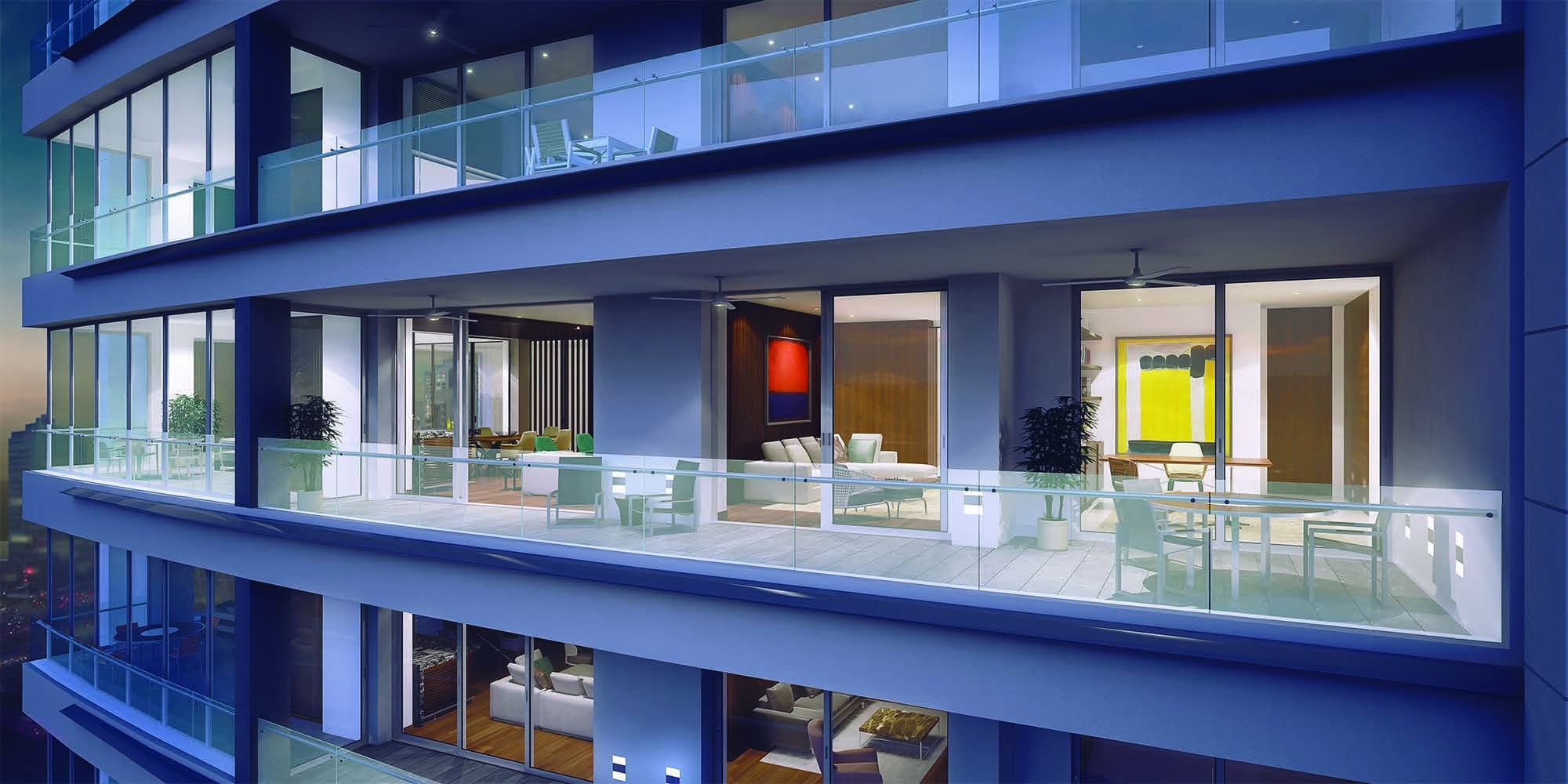Rendering of Marea II glass-railed balconies with lit living rooms at dusk