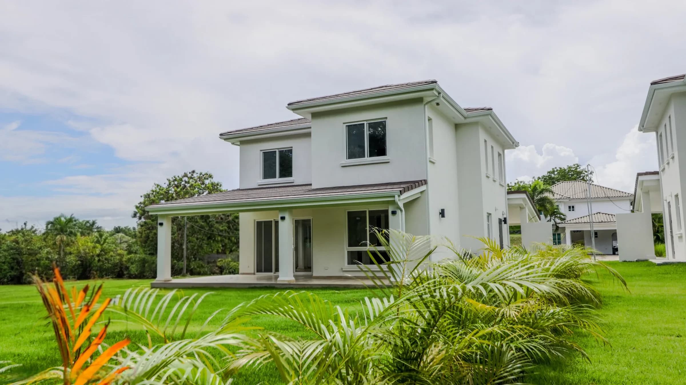 Veranera house exterior with covered terrace and landscaped garden in Bijao Beach Club
