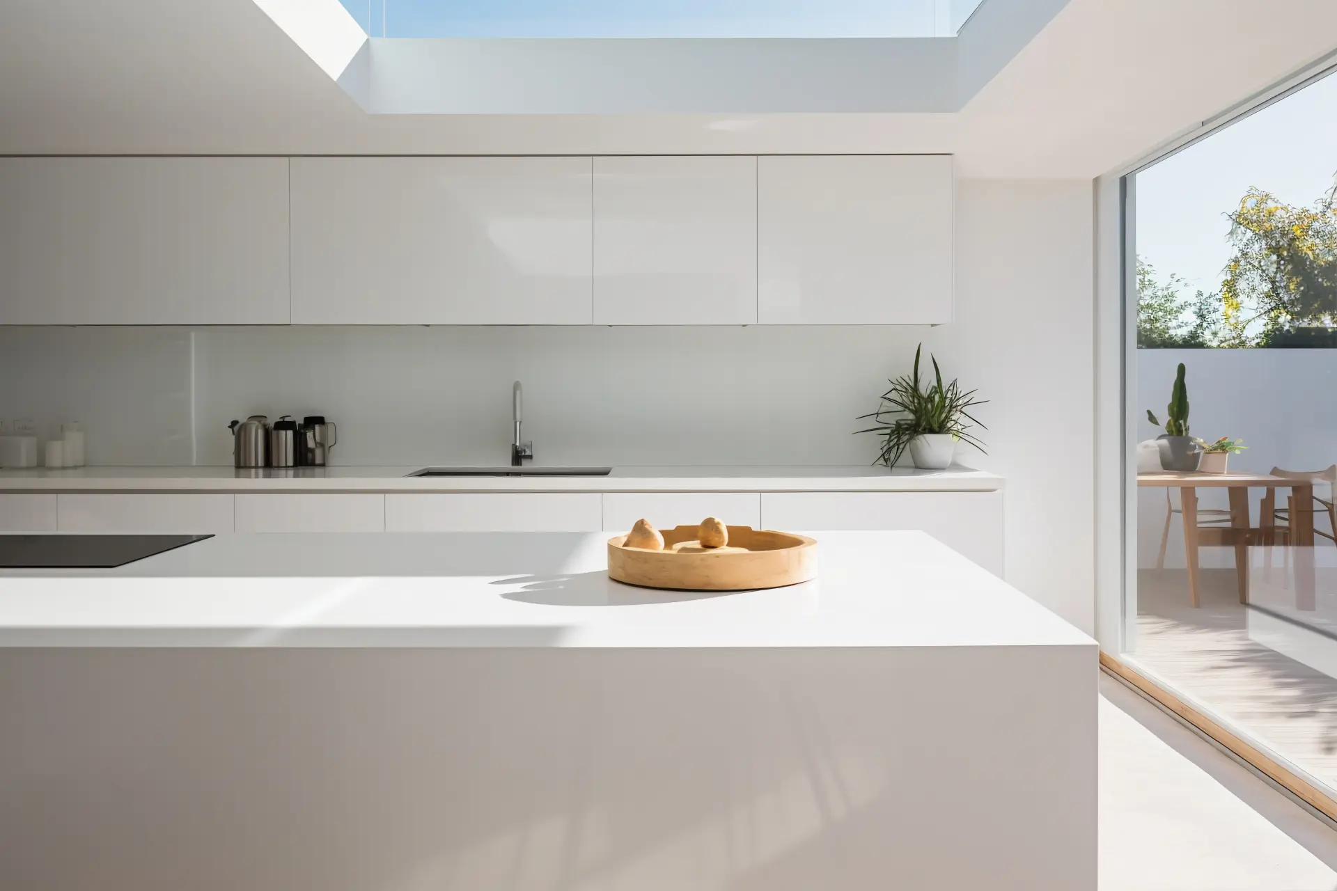 White Italian kitchen with skylight and garden view in a Veranera house