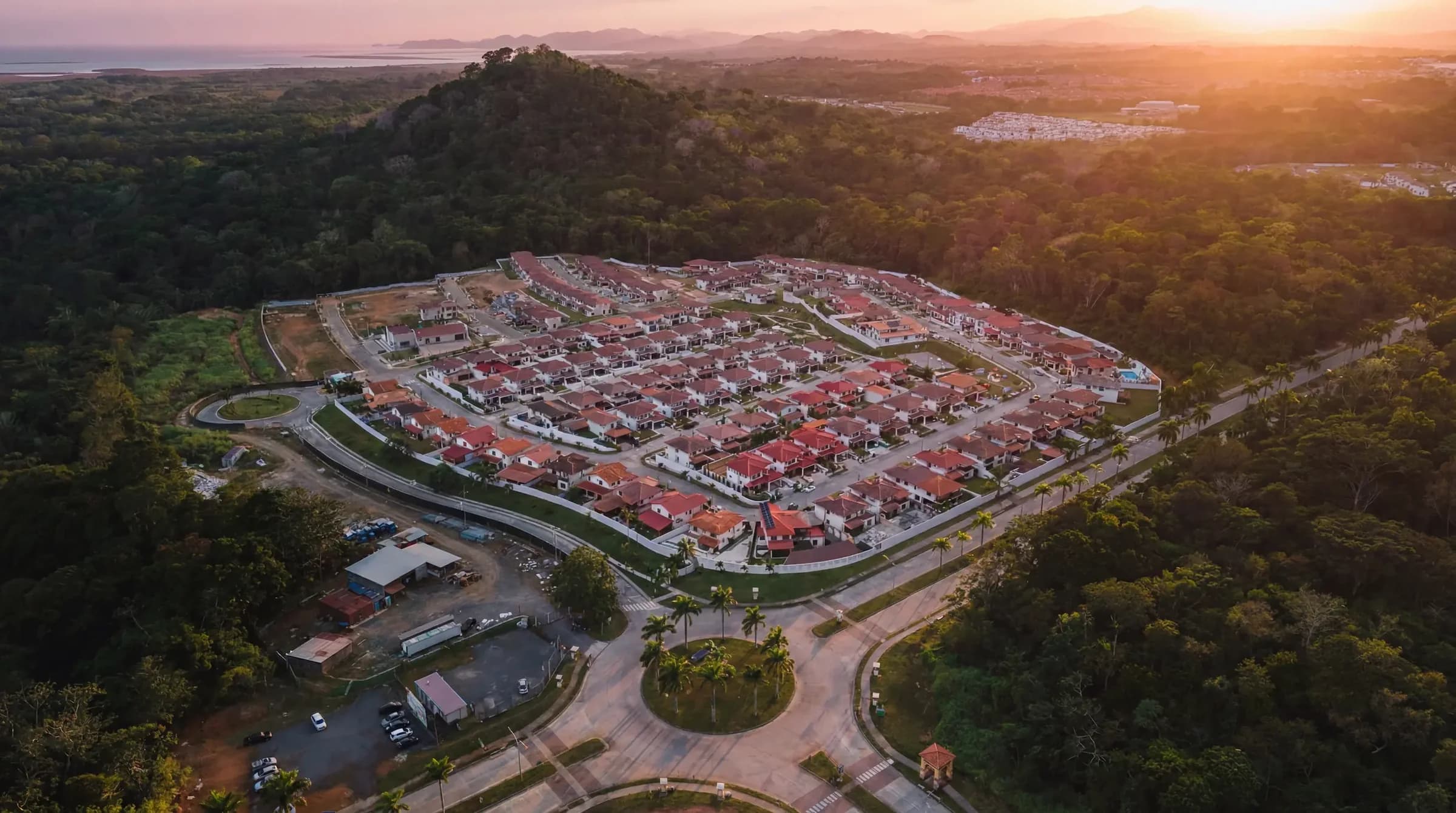 Aerial view at sunset of the Arcadia gated community among the green hills of Costa Verde, La Chorrera