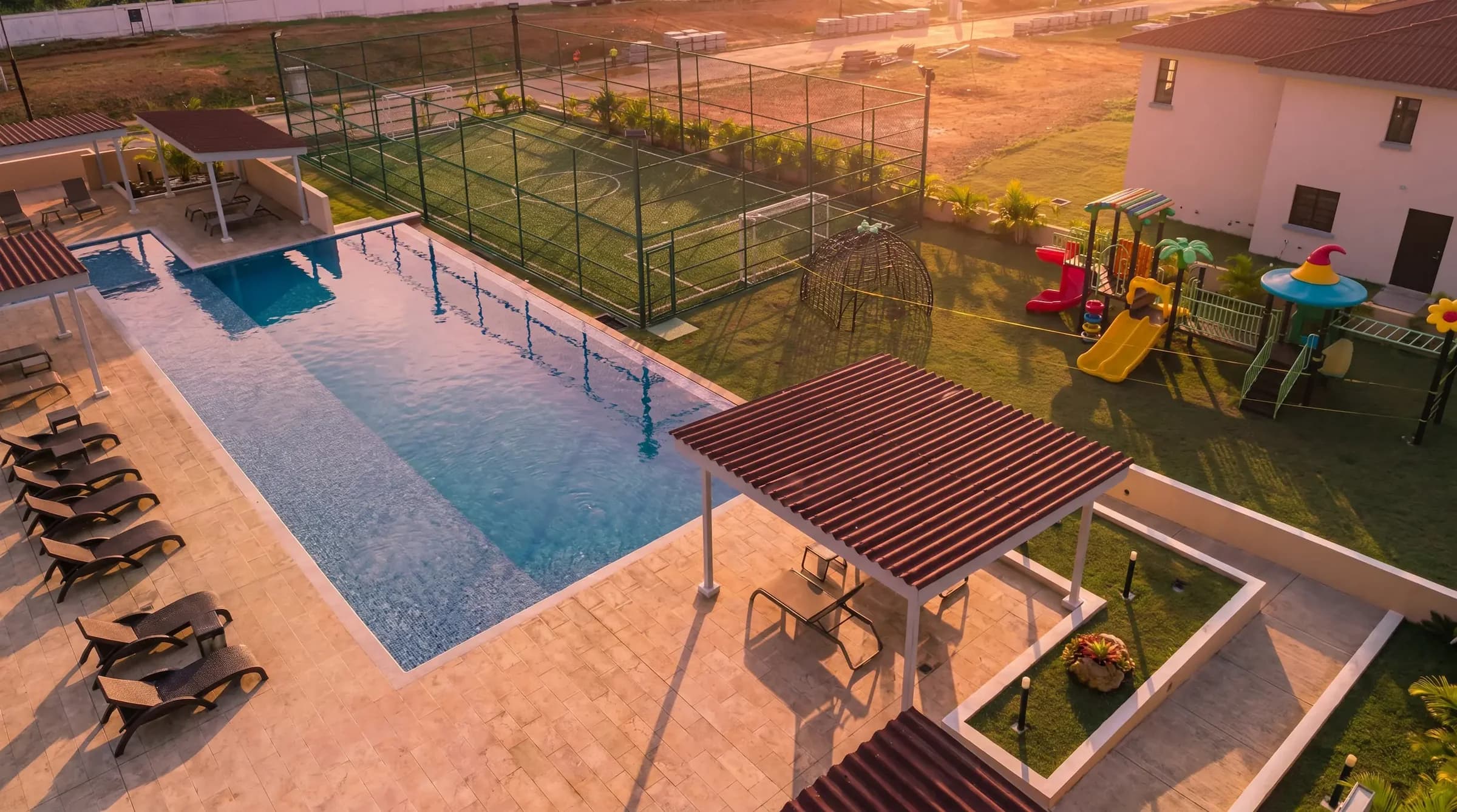 Aerial view of the Arcadia pool deck with loungers, gazebo, playground and sports court, Costa Verde