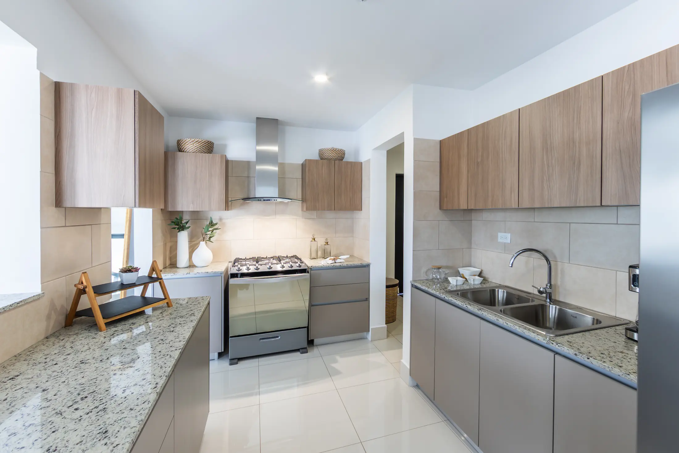 Kitchen with granite counters and wood cabinets in an Arcadia model house, Costa Verde
