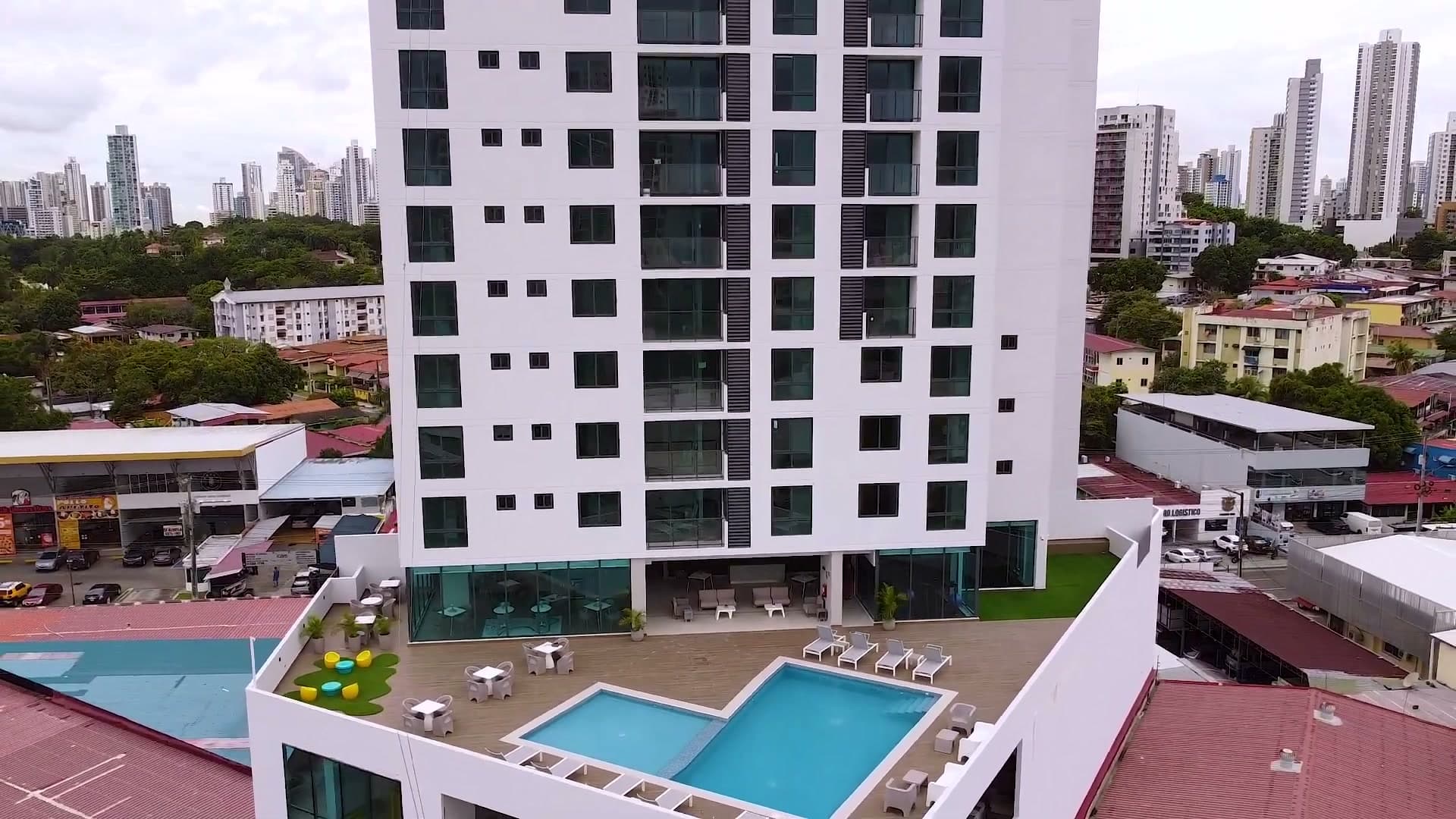 Drone view of the Época Parque Lefevre podium terrace, pool and tower facade