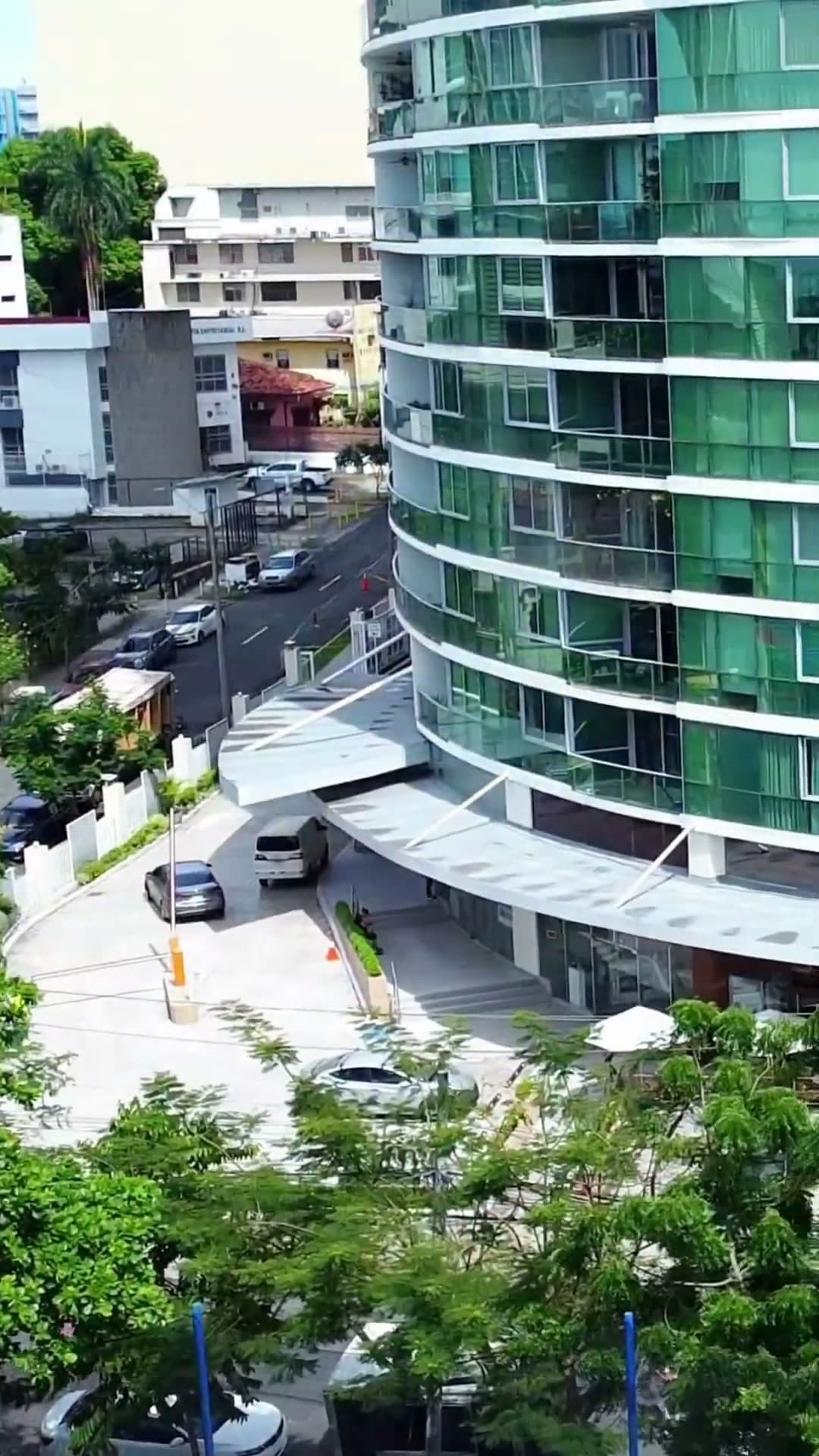 Aerial view down the curved glass facade of Allure at the Park toward the Park Shops entrance