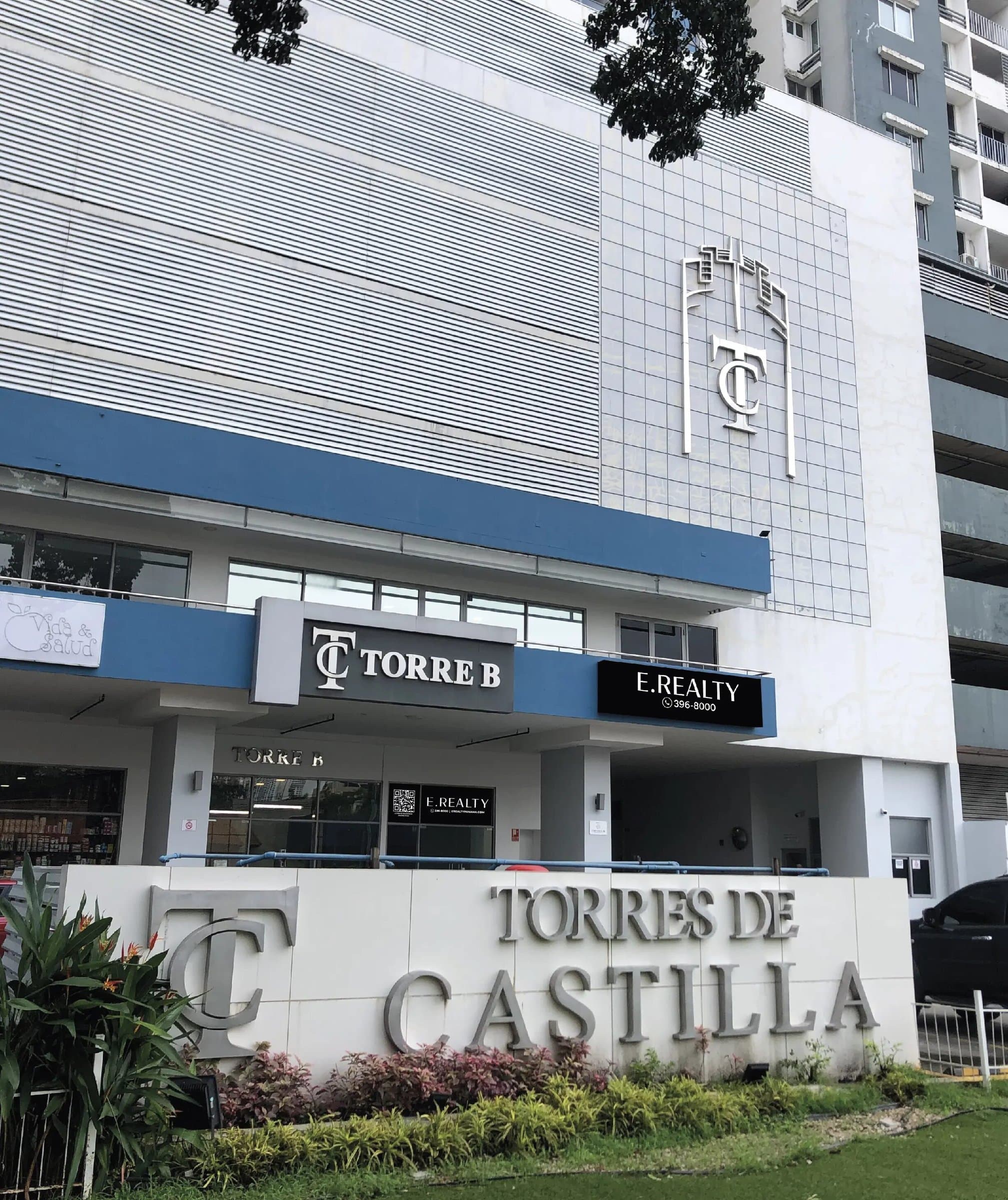 Torres de Castilla sign and commercial level with mezzanine storefronts on Vía España