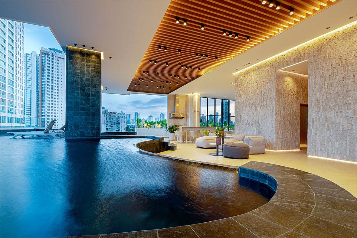 Indoor pool and lounge under a wood-slat ceiling at Victory Wellness