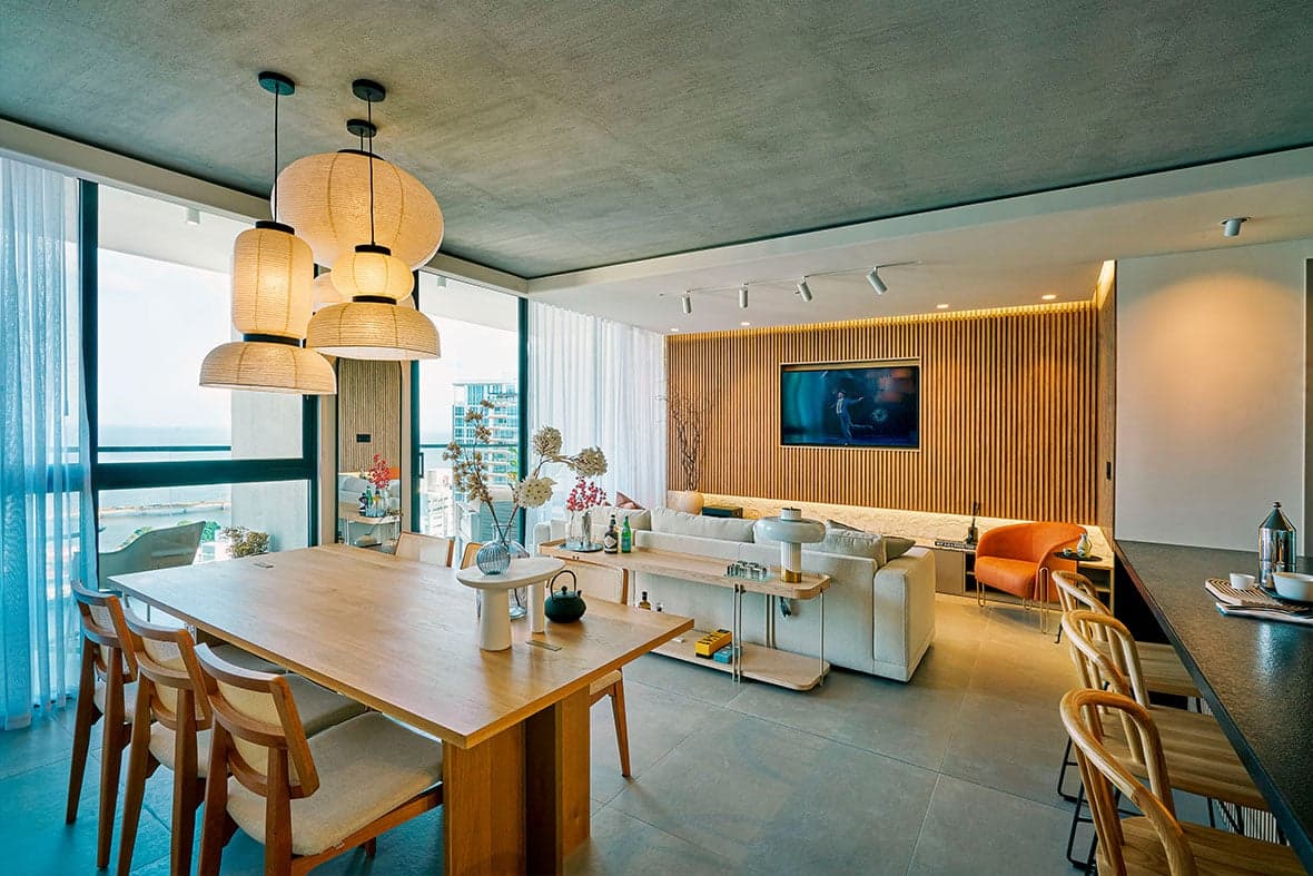 Open living and dining room with pendant lamps in a Victory Wellness apartment