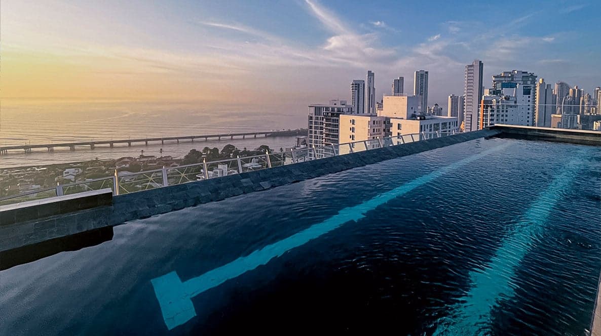 Infinity pool at sunset overlooking the bay and the Panama City skyline at Victory Wellness