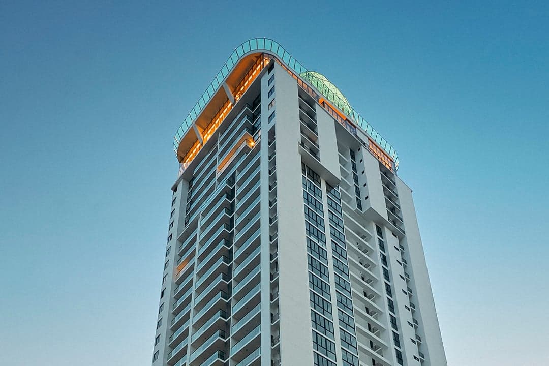 Upward view of the Victory Wellness tower and its rooftop glass dome
