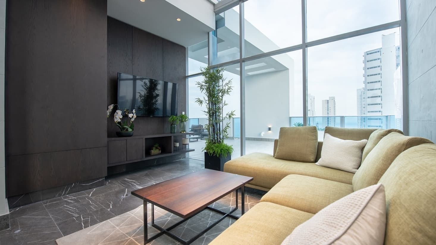 Living room with sectional sofa and floor-to-ceiling windows in a Vita apartment