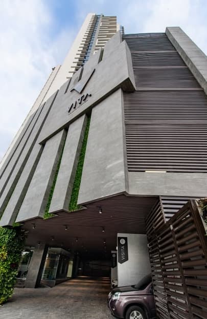 Vita residential tower facade with vertical gardens above its entrance in Coco del Mar
