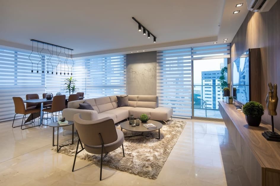 Living and dining room with sectional sofa in a Vita apartment