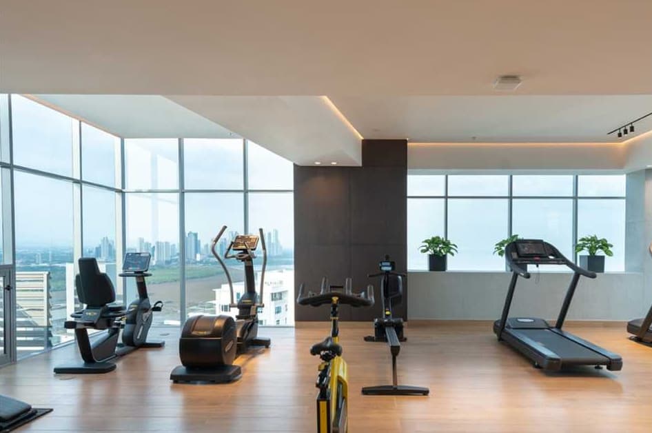 Gym with cardio machines and floor-to-ceiling windows at Vita