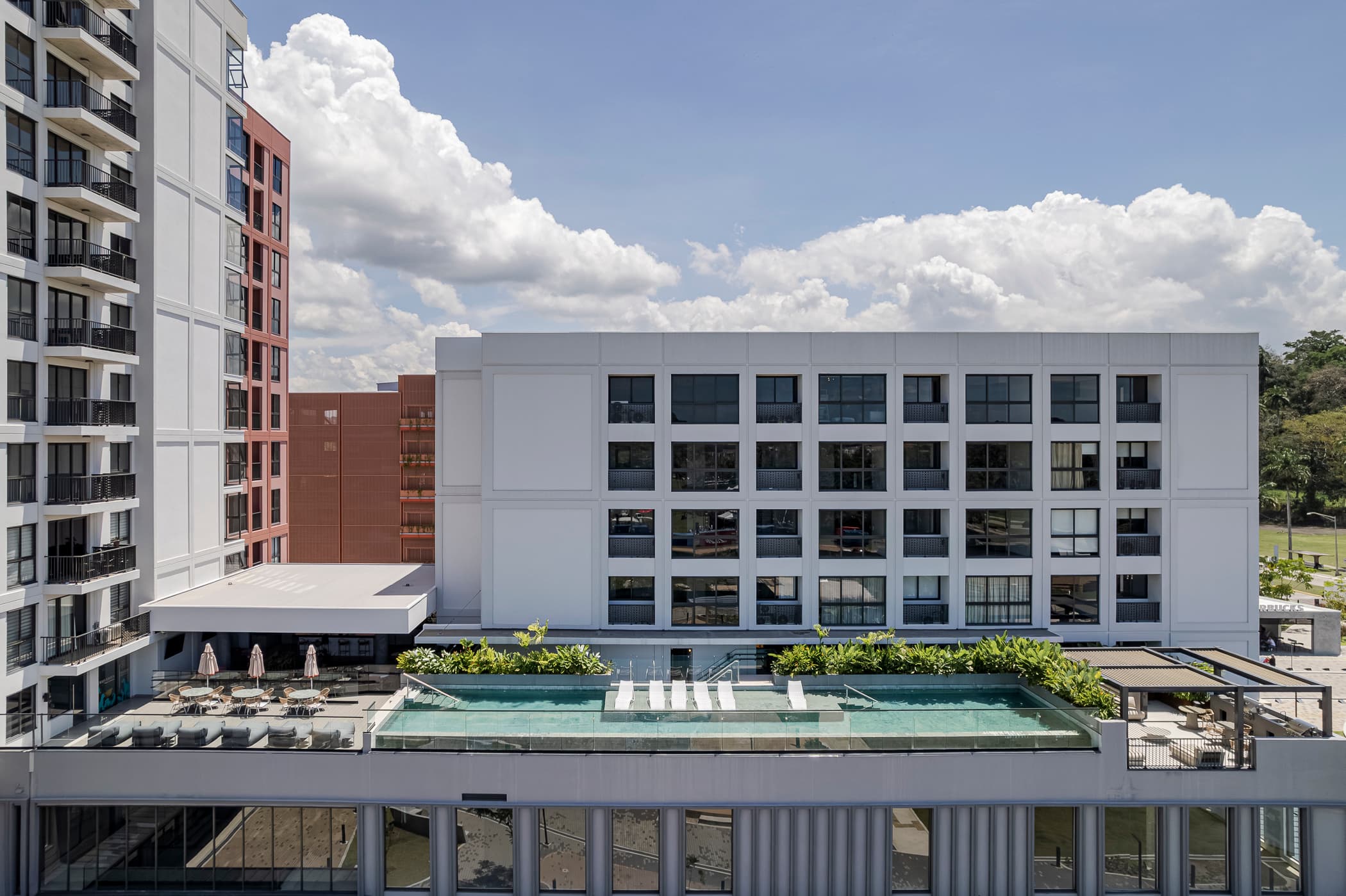 Cëntriqo building with its sky pool and sun deck on the podium roof