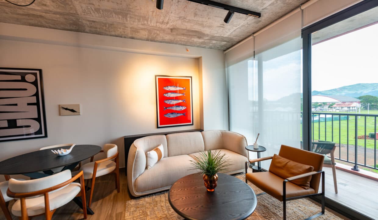 Living room with balcony and park views in a Cëntriqo apartment