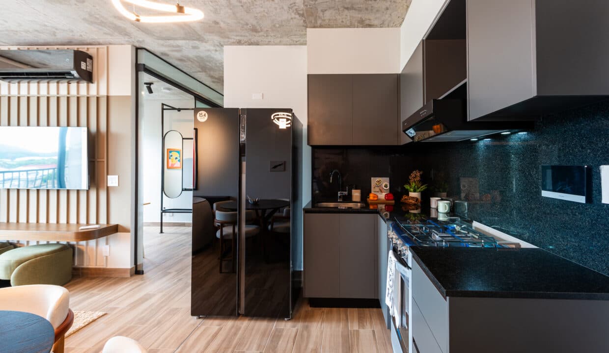 Kitchen with black cabinets and gas range in a Cëntriqo apartment