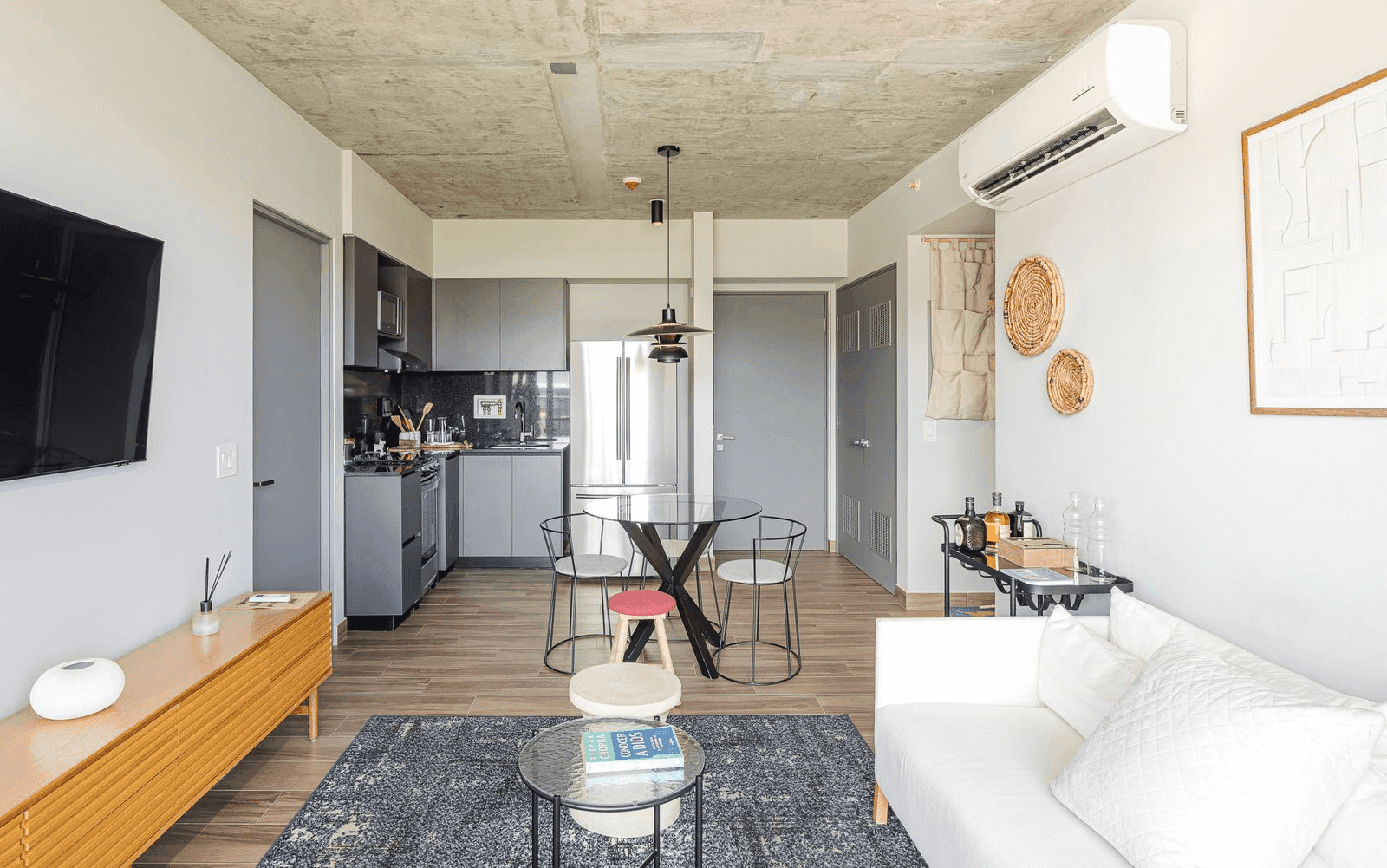 Open living, dining and kitchen area in a Cëntriqo apartment