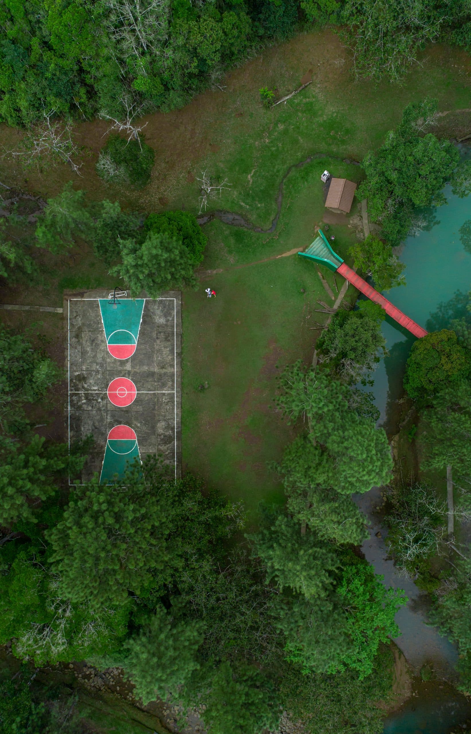 Aerial view of a sports court beside a river in the forest at Los Altos de Cerro Azul