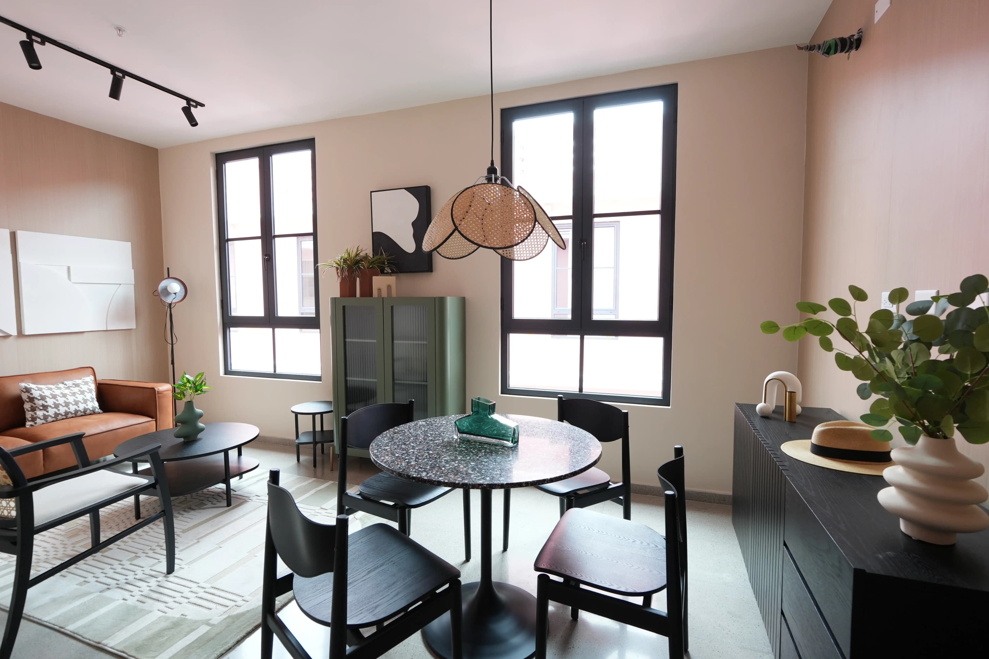 Living and dining room with tall windows in a La Quince apartment