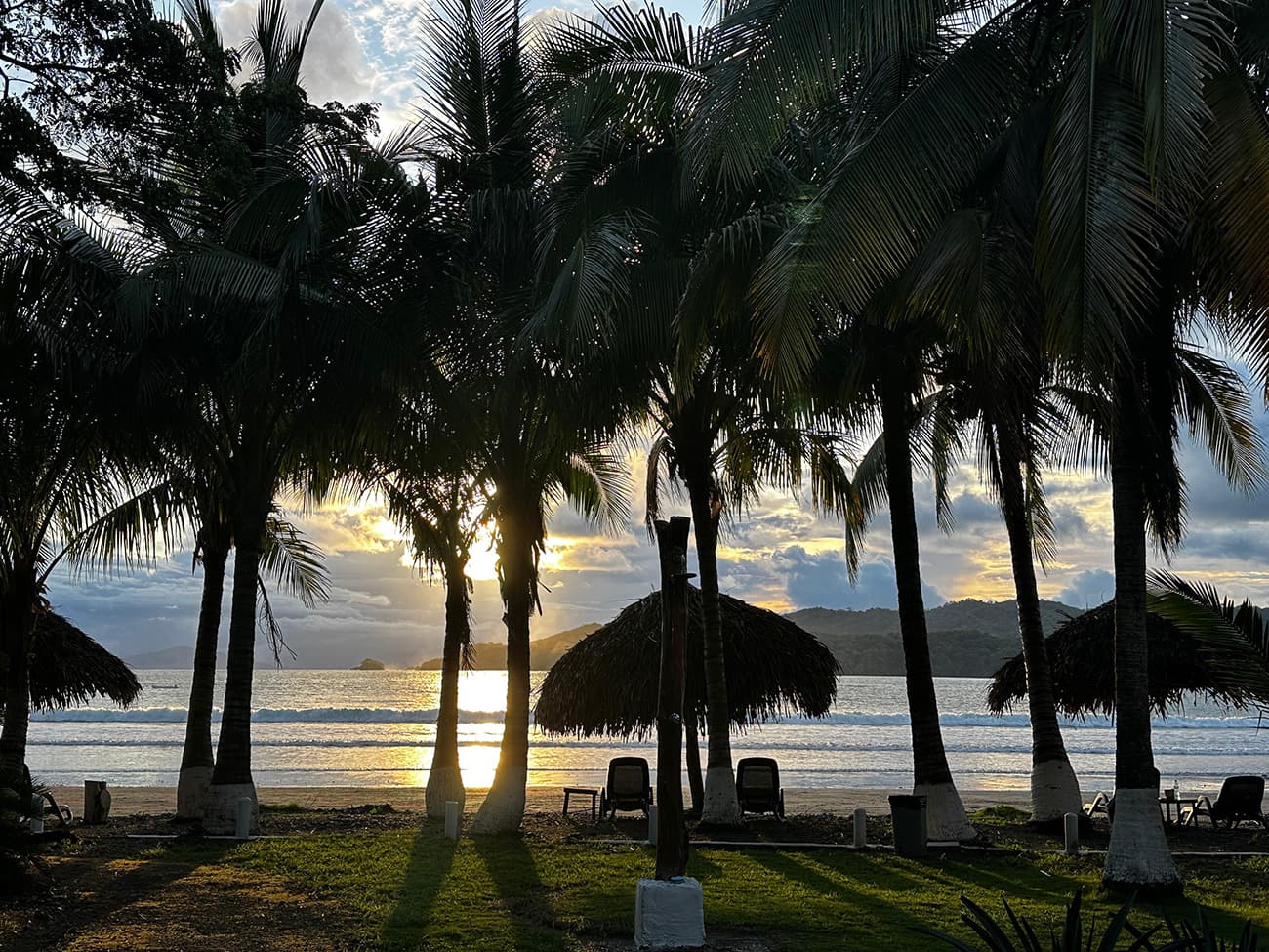 Sunset over Playa Venao through the palm trees at Villa Marina