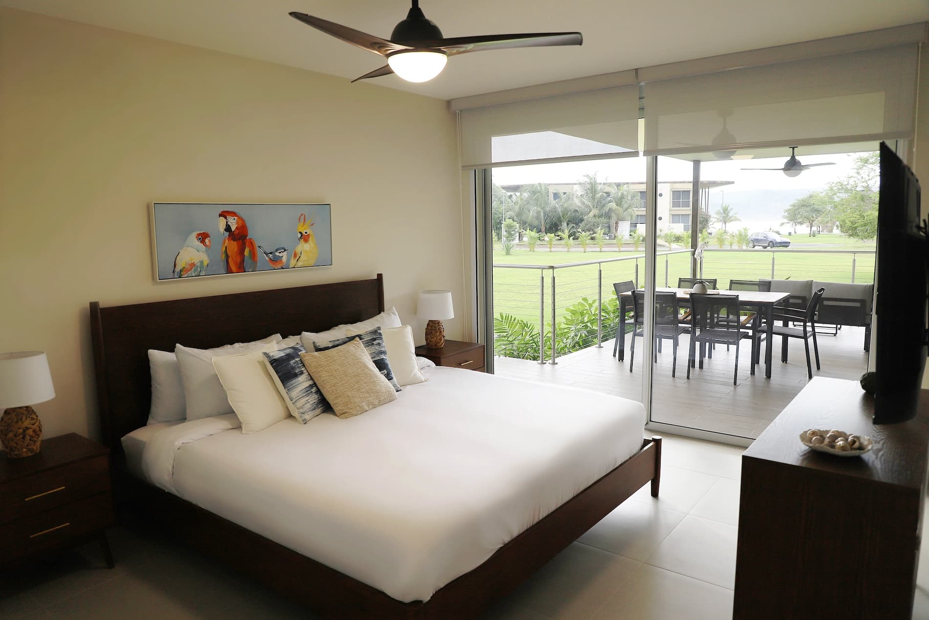 Main bedroom opening onto a furnished terrace in a Villa Marina condo