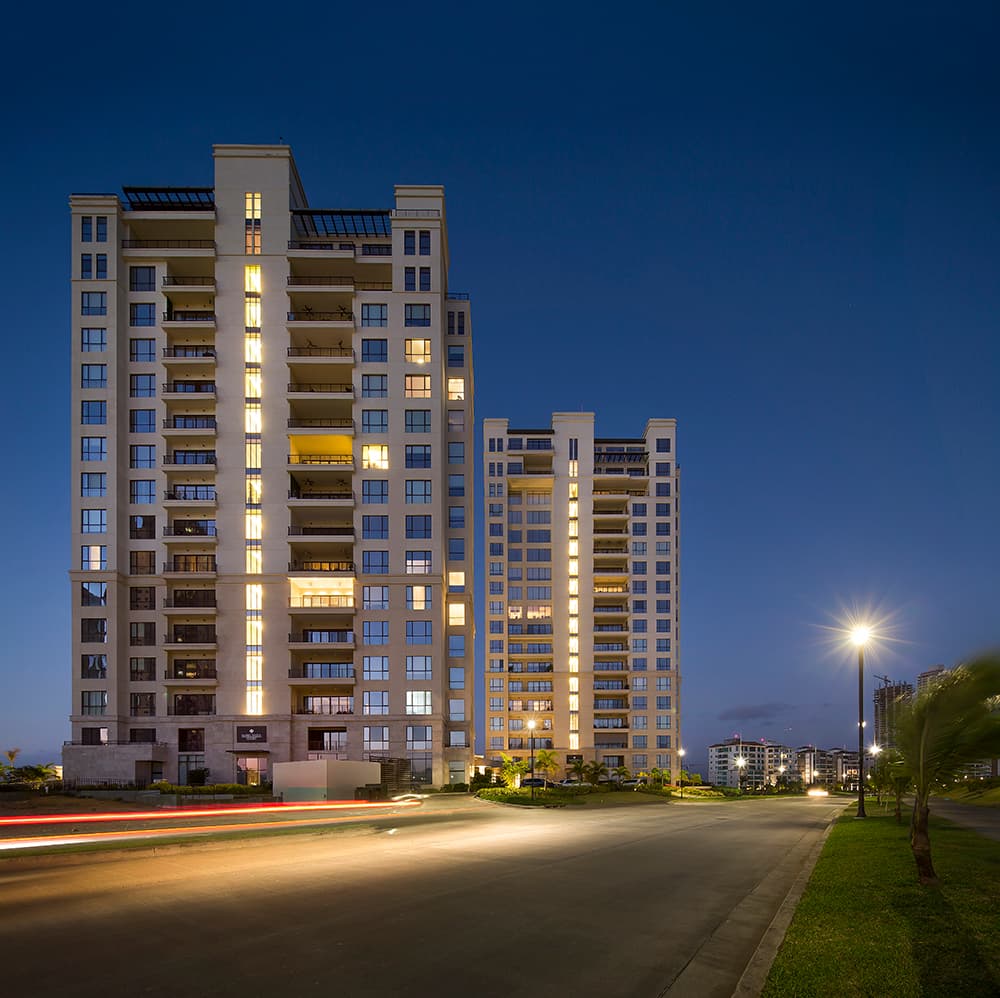 Santa María Court East and West towers lit at dusk in Santa Maria Golf & Country Club, Panama City