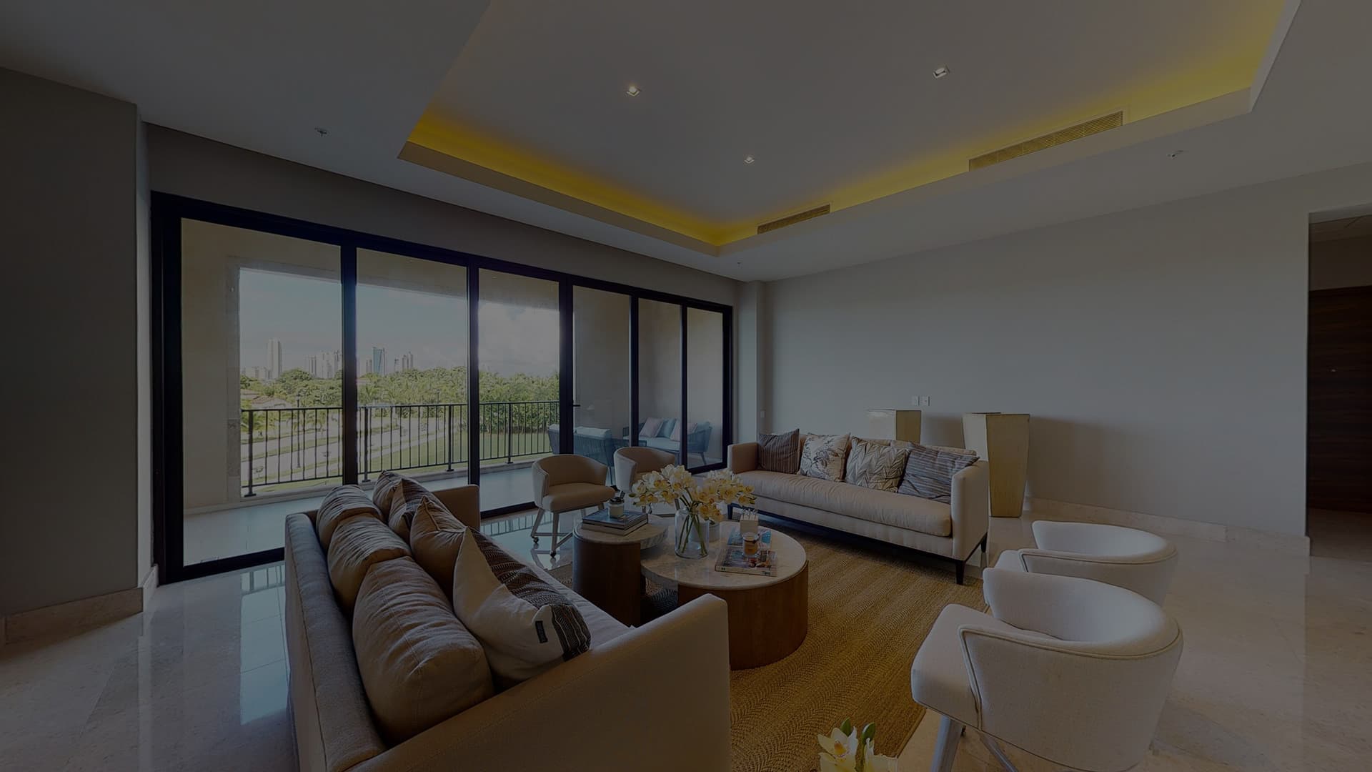 Living room with floor-to-ceiling windows and golf course views at Santa María Court