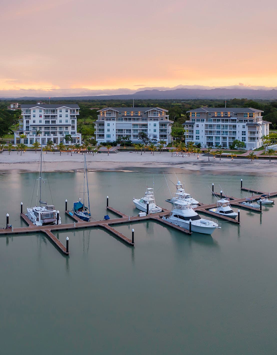 Aerial view of the Buenaventura Marina docks and the Marina Village buildings of Marine Lodge at sunset