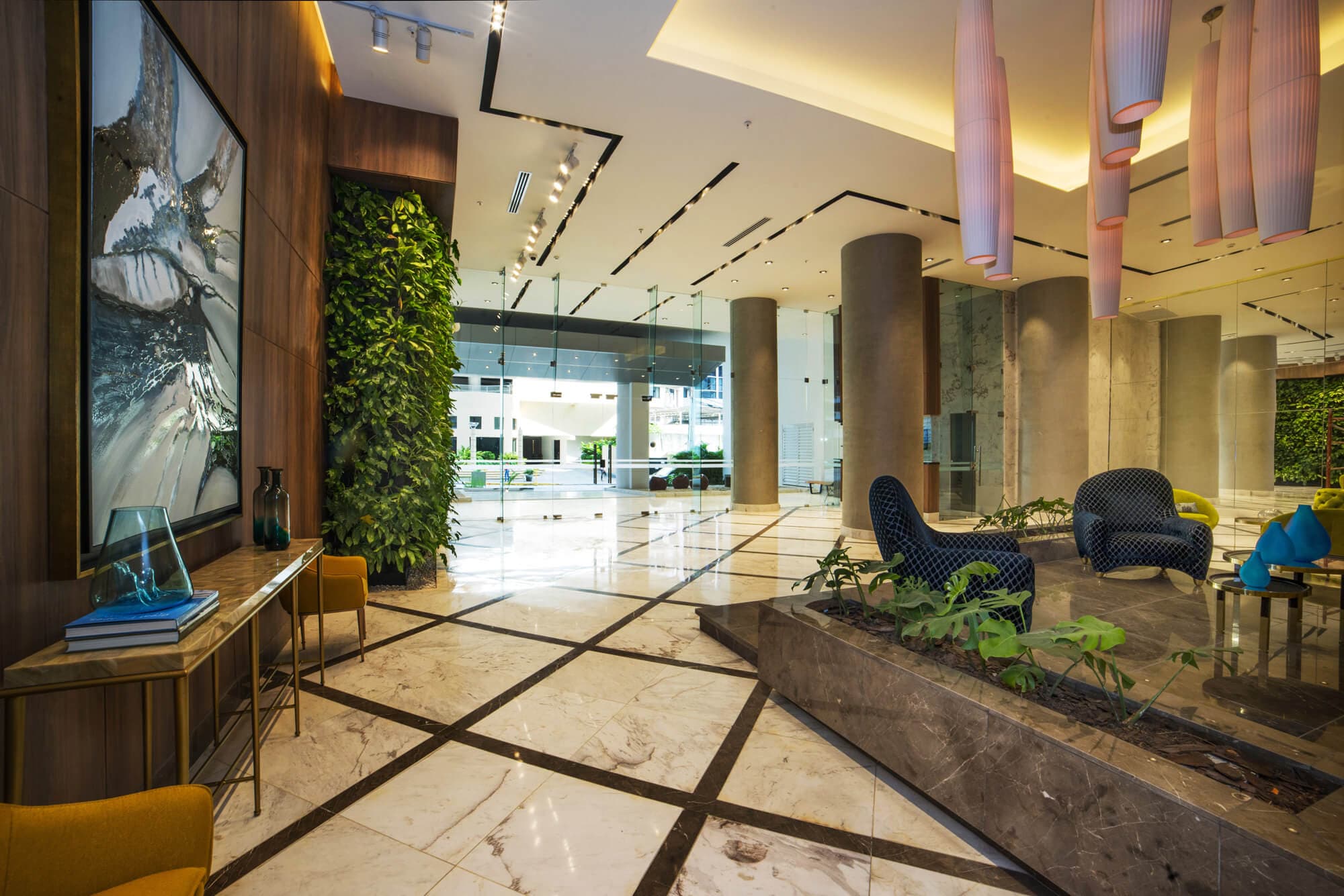 Deluxe Residences lobby with marble floors and vertical garden