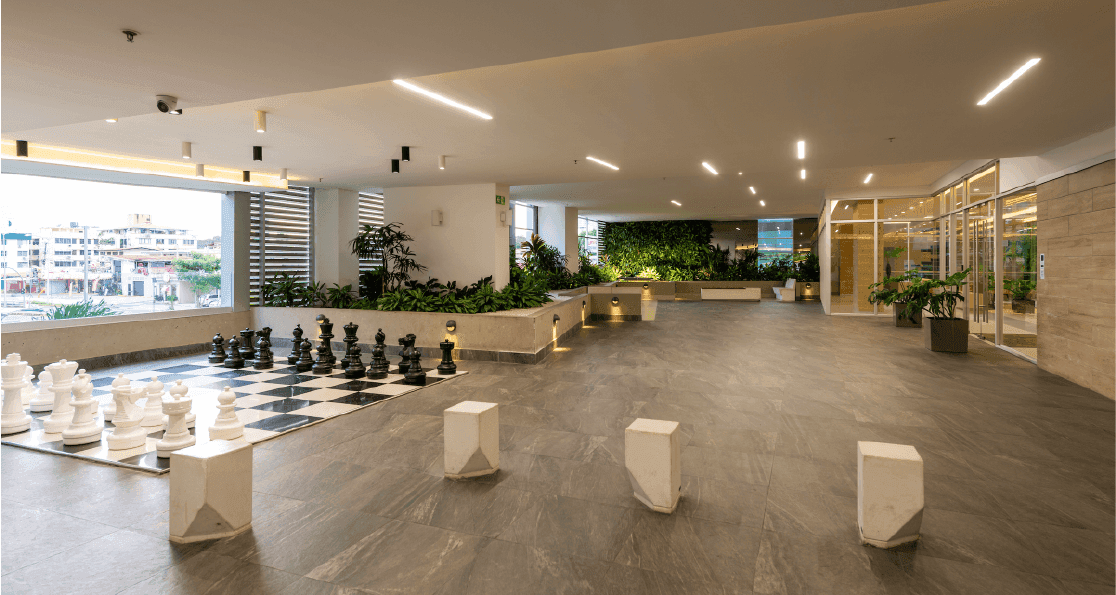 Vivendi Green social area with giant chess set and indoor garden