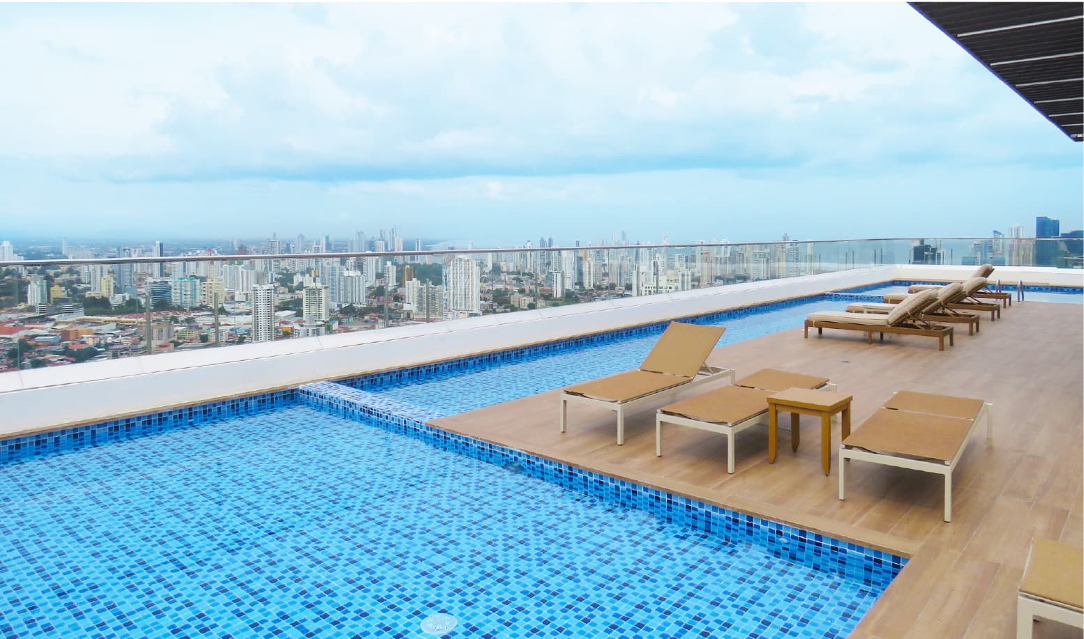 Pacific Park rooftop pool with loungers and panoramic city views