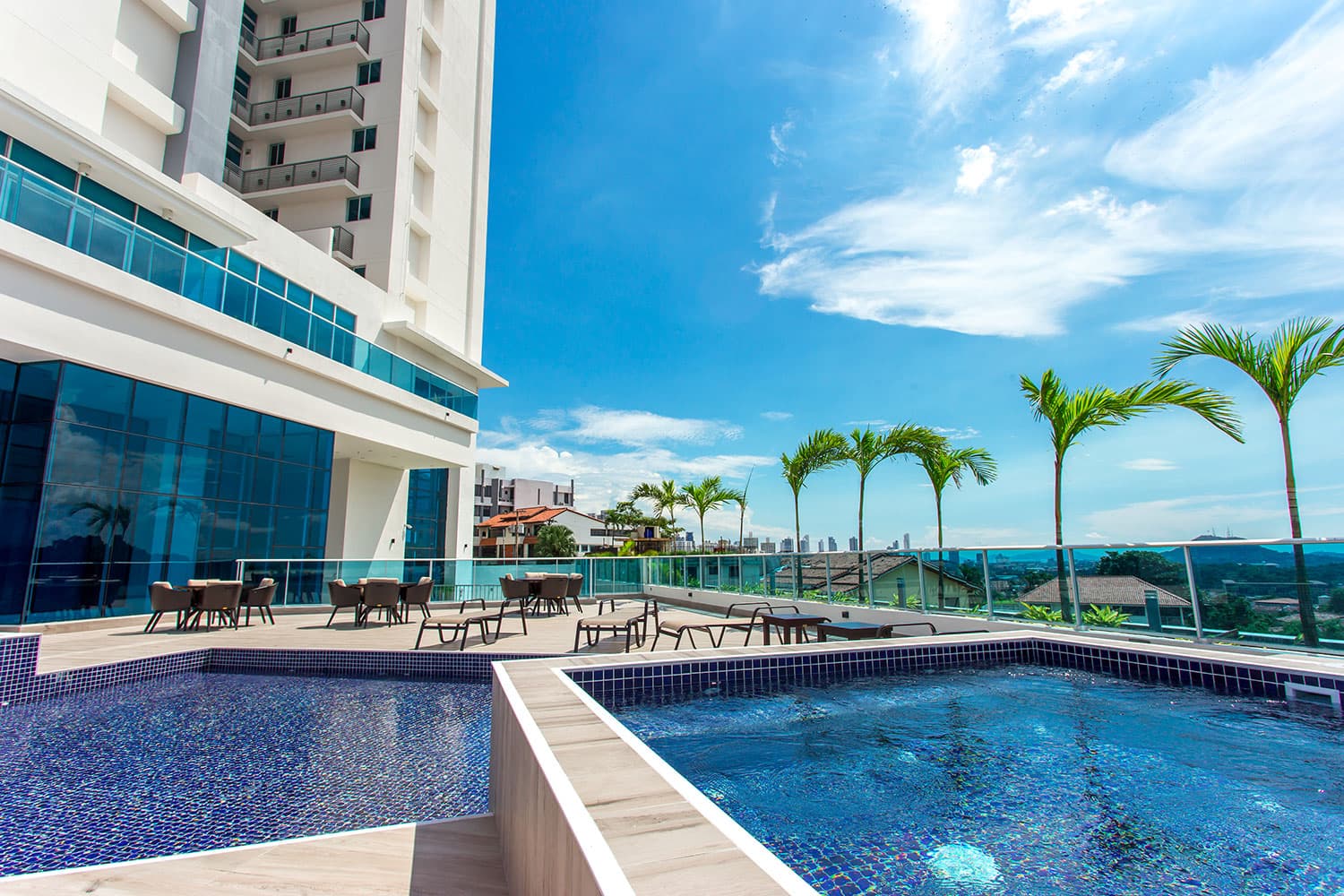 Elite 500 pool deck with palm trees and views over Dos Mares