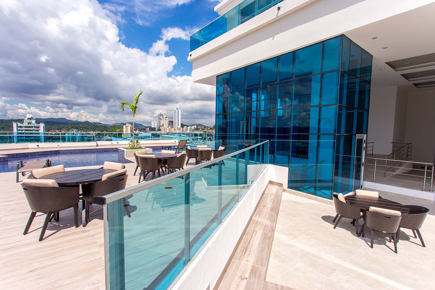 Elite 500 terrace with outdoor dining tables beside the glass facade