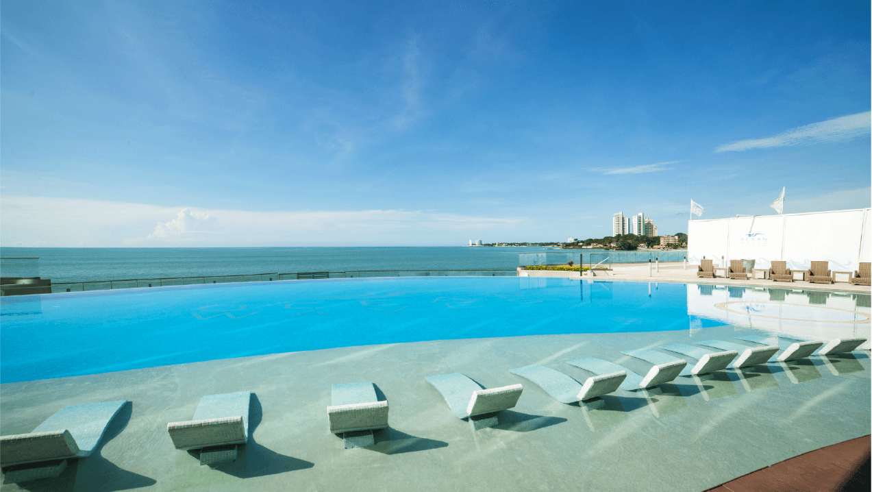 Ocean Waves infinity pool with in-water loungers facing the ocean